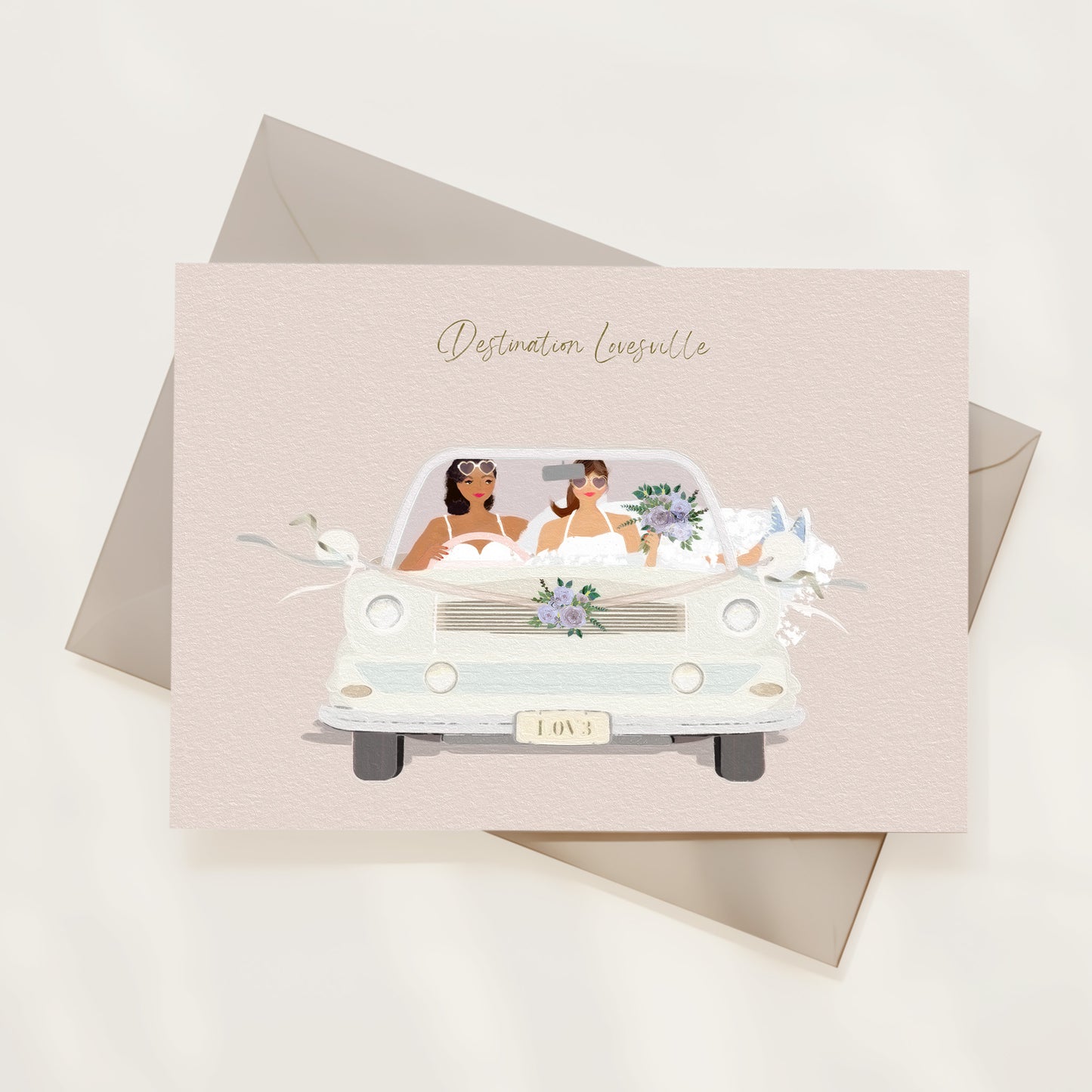 Greeting card with illustration of a car carrying two brides, set against a light background.