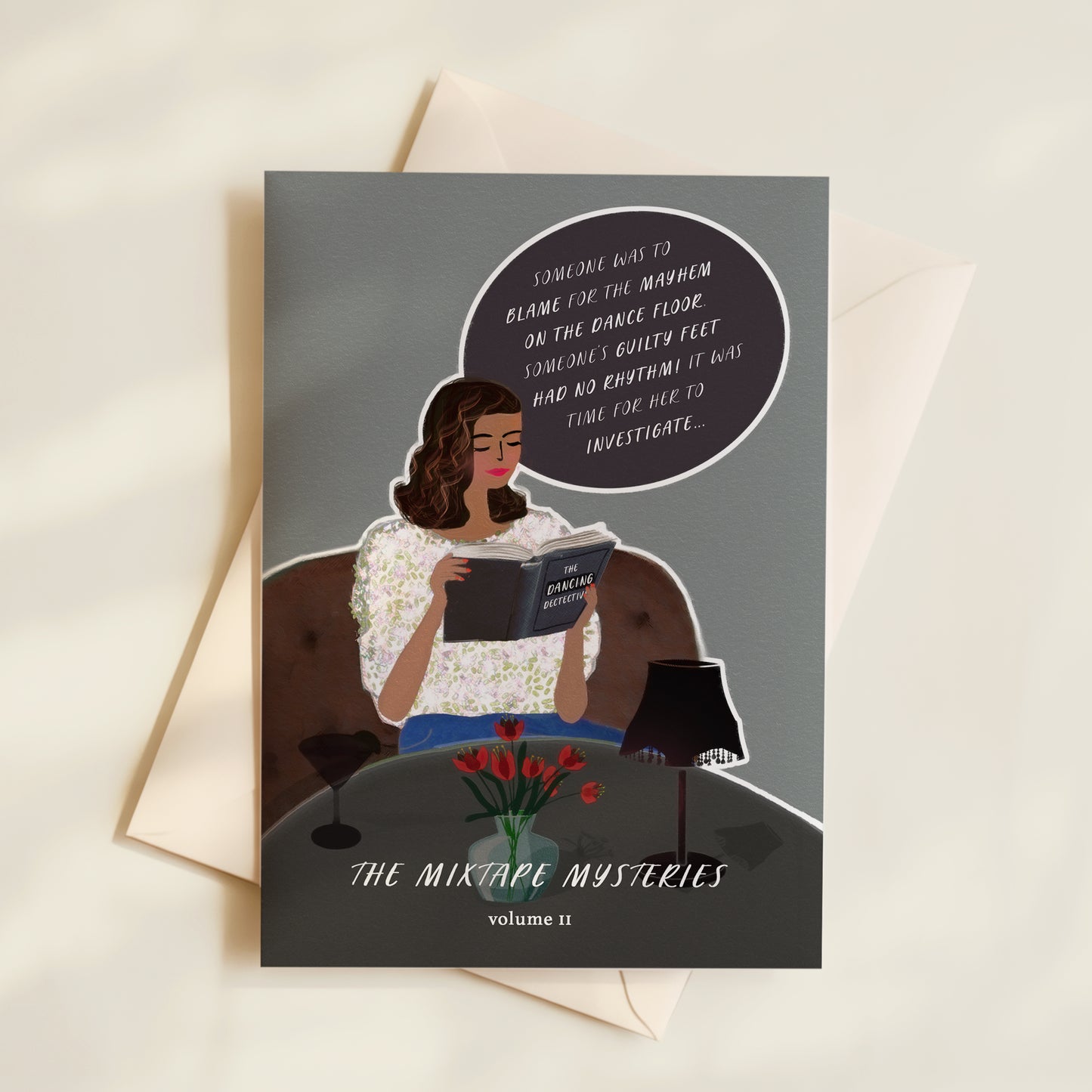 Greeting card with illustration of a woman reading a book titled 'The Mixtape Mysteries' on a grey background.