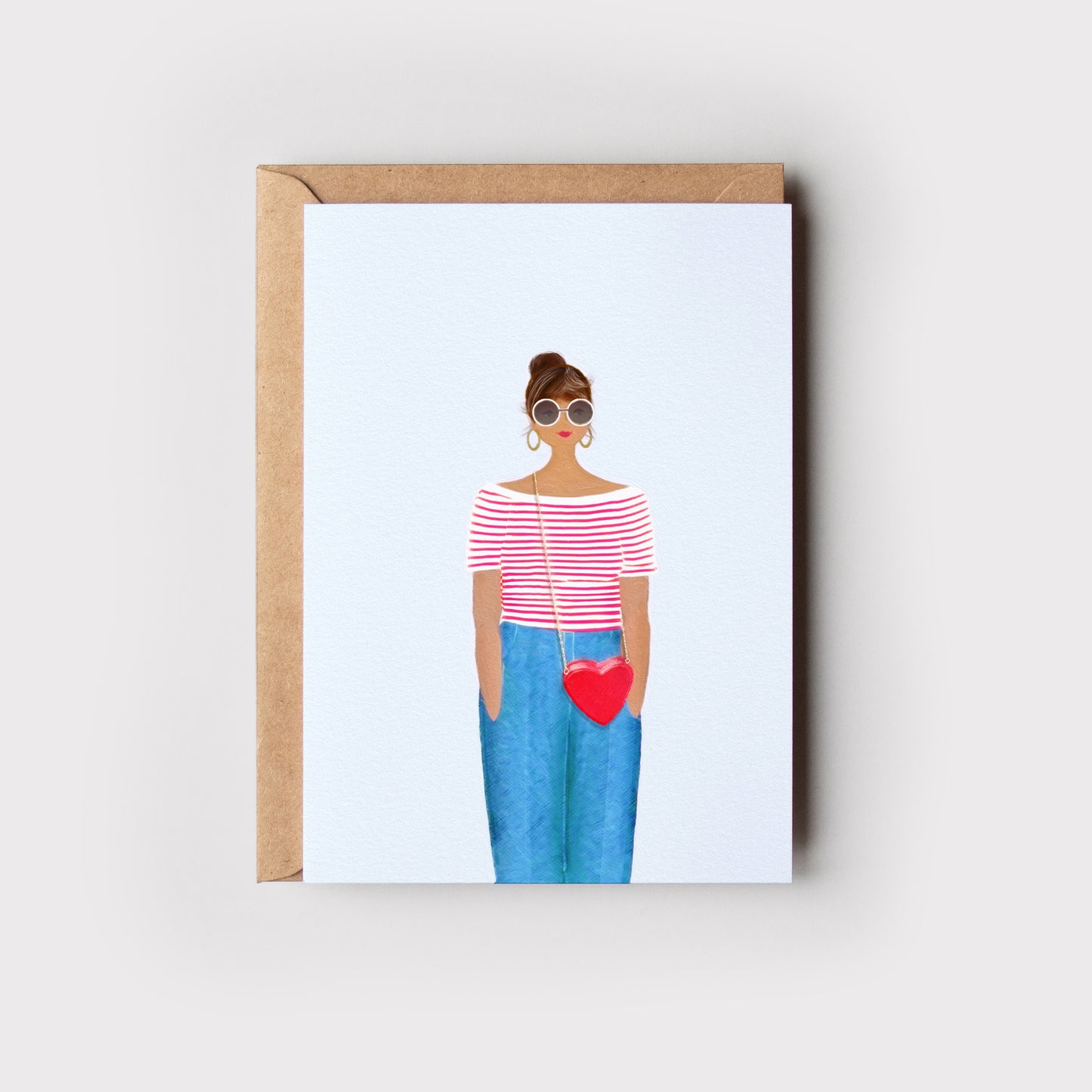 Greeting card with illustration of a person wearing sunglasses and holding a heart-shaped bag, on a light background and with an envelope.