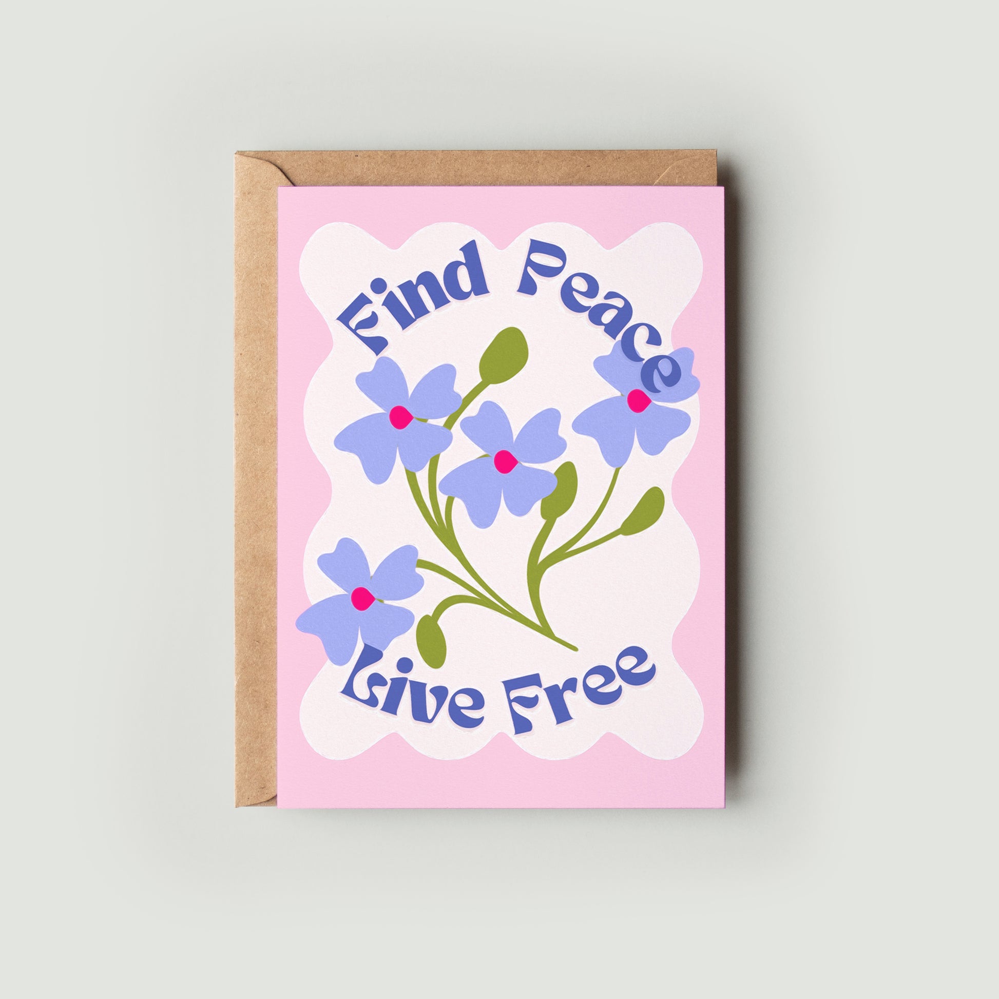 A greeting card with a floral design and the text 'Find Peace Live Free' on the front, accompanied by a kraft envelope.