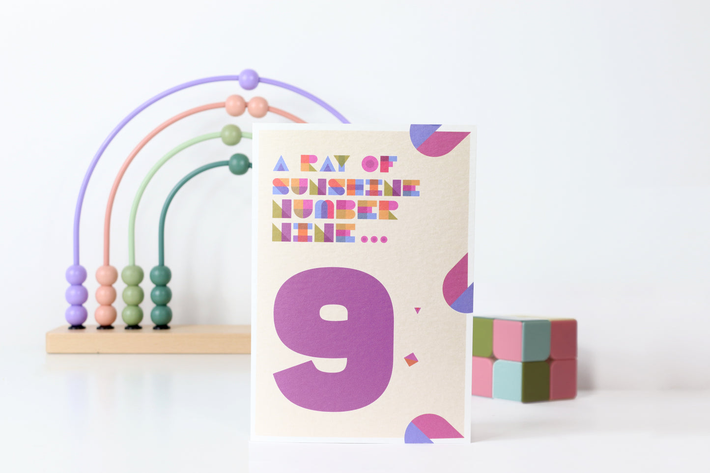 Card with number 9 and colorful abacus on a white background