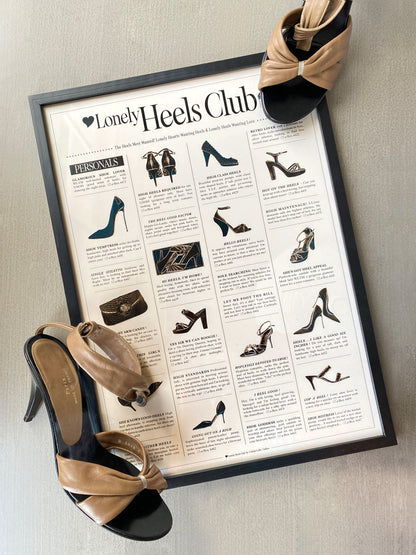 Framed 'Lonely Heels Club' poster with high-heeled shoes on a neutral background
