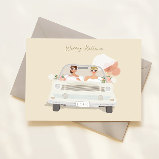 Greeting card with illustration of two women in a car, labelled 'Wedding Belles', on a beige background.