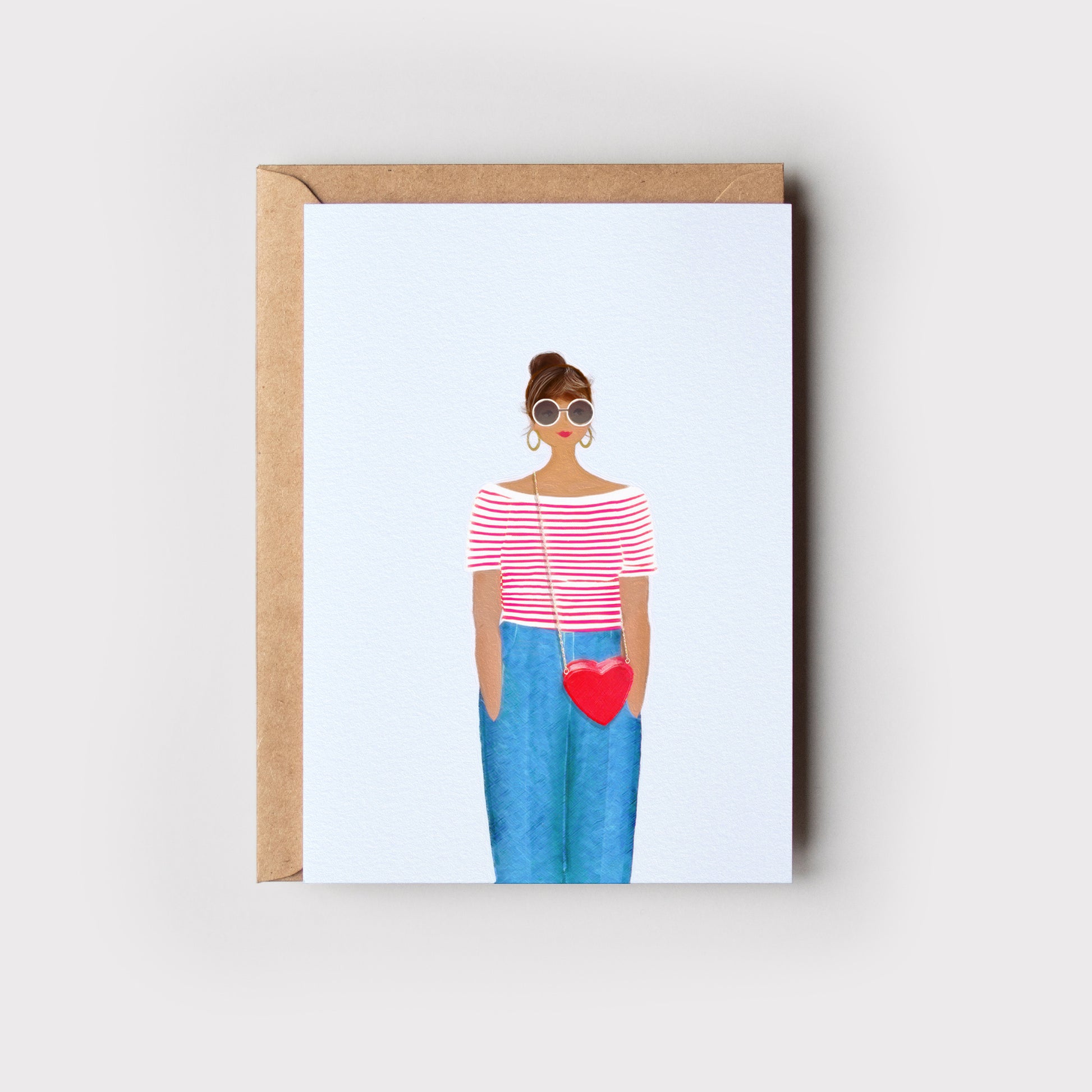 Greeting card with illustration of a person wearing sunglasses and holding a heart-shaped bag, on a light background and with an envelope.